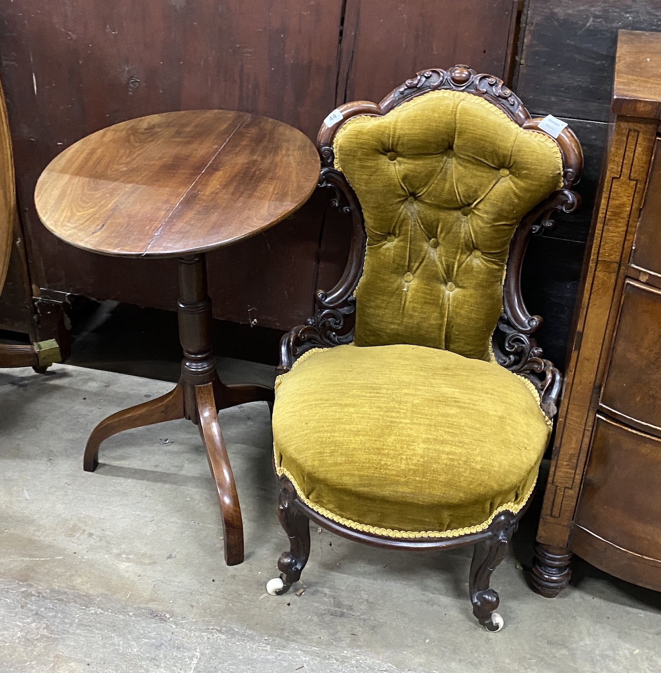 A Victorian carved mahogany nursing chair, together with an early 19th century oval mahogany wine table